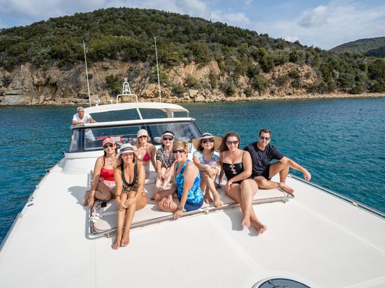 The group lounging on the boat's bow